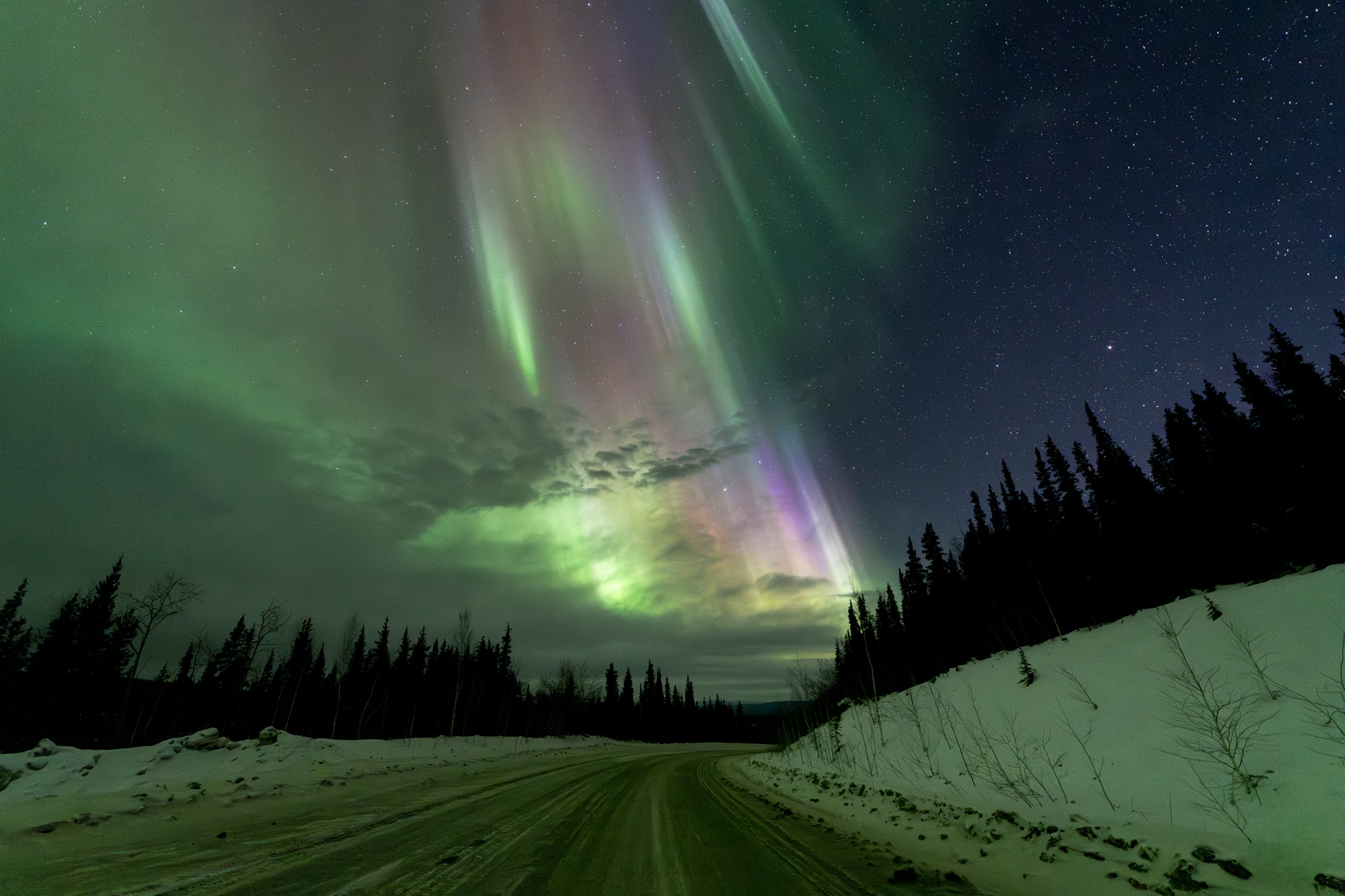 Aurora curtains above a road in Alaska