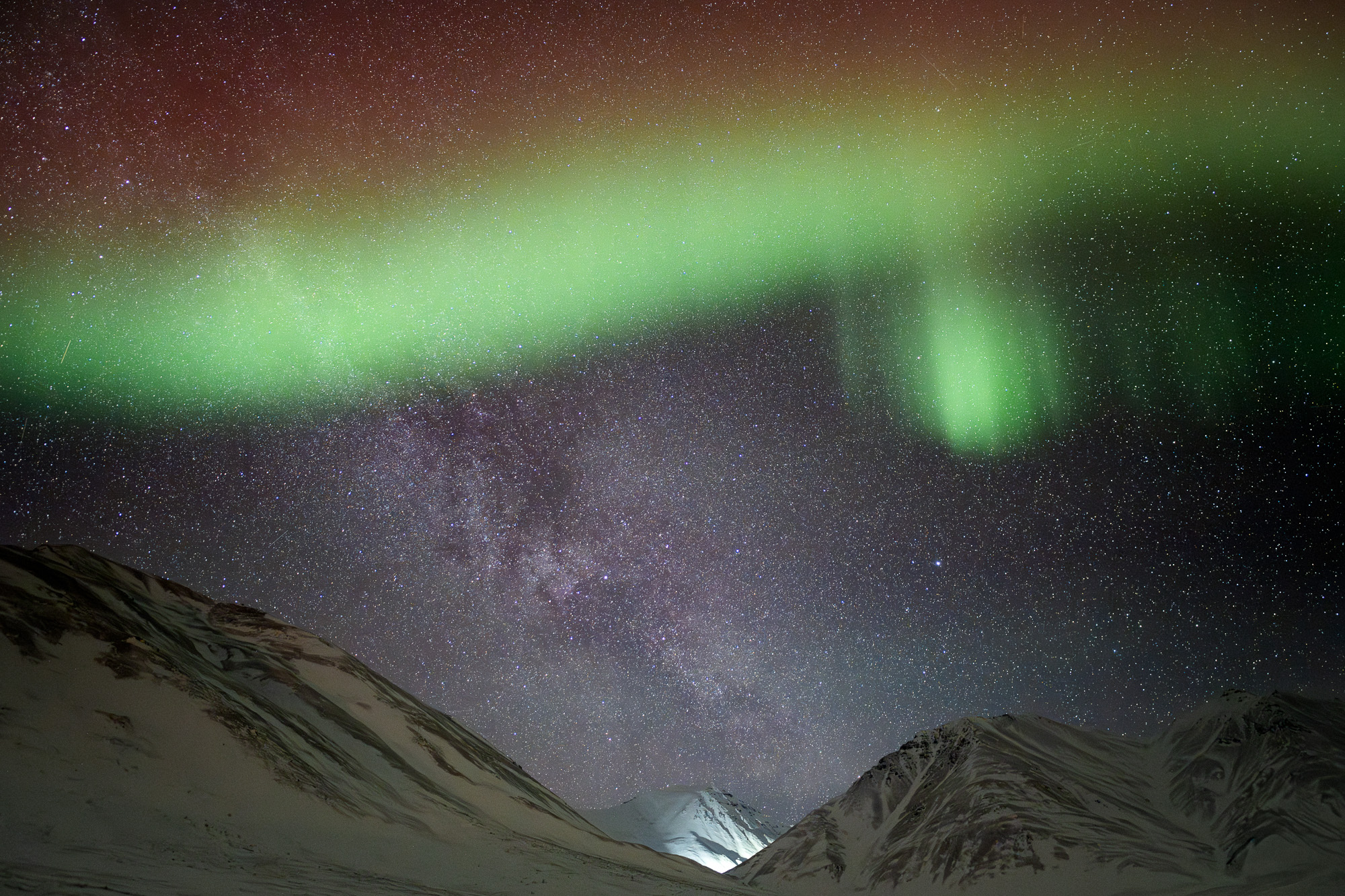 Aurora and Milky Way above Alaskan mountains