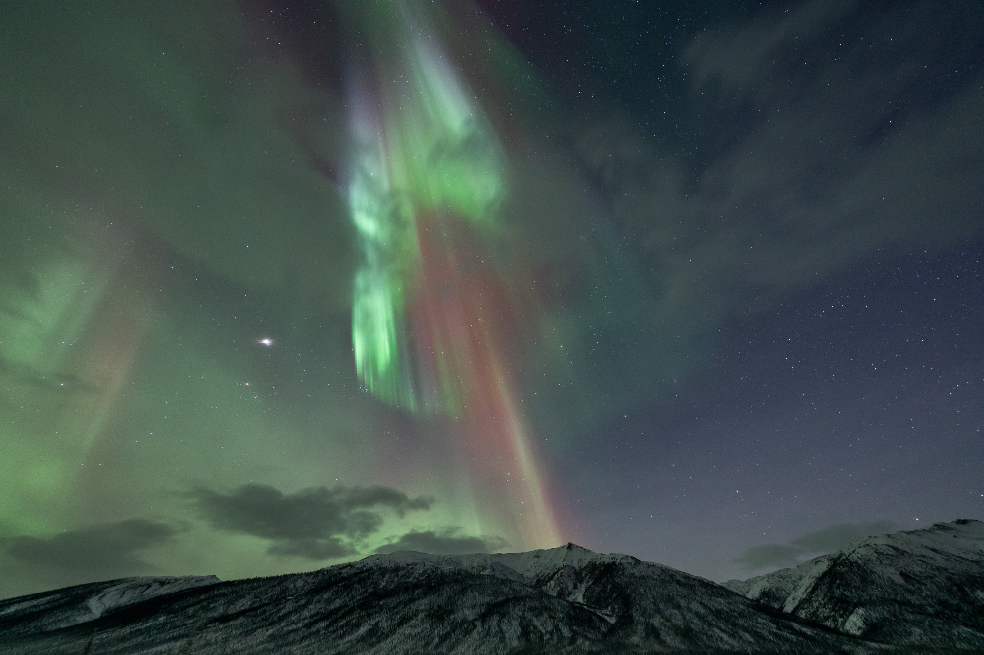 Aurora needles above mountains in Alaska
