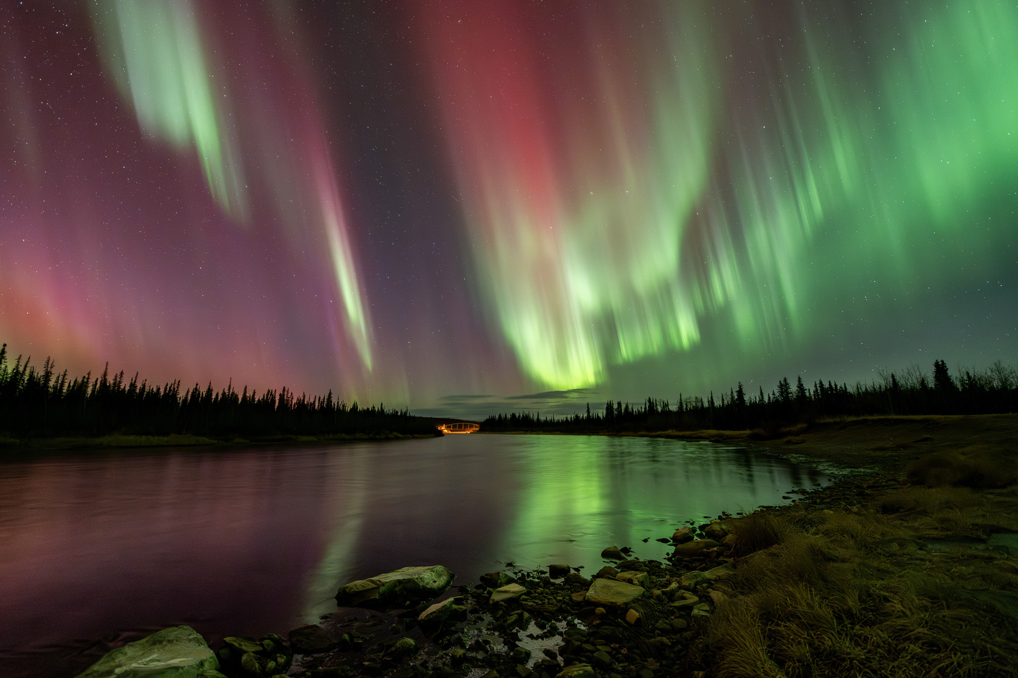 Aurora reflecting on a river in Alaska