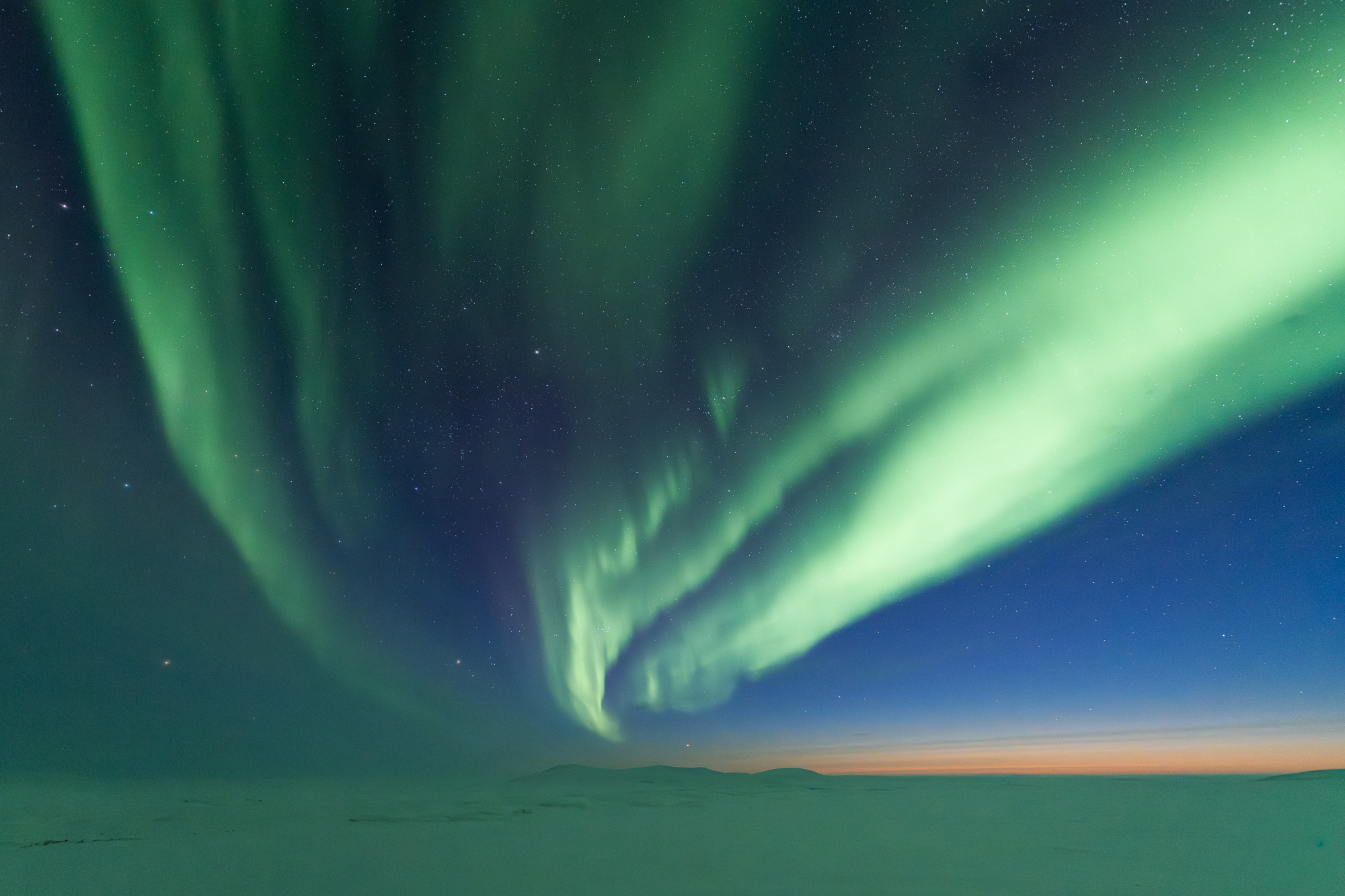 Aurora over the Alaskan tundra at twilight