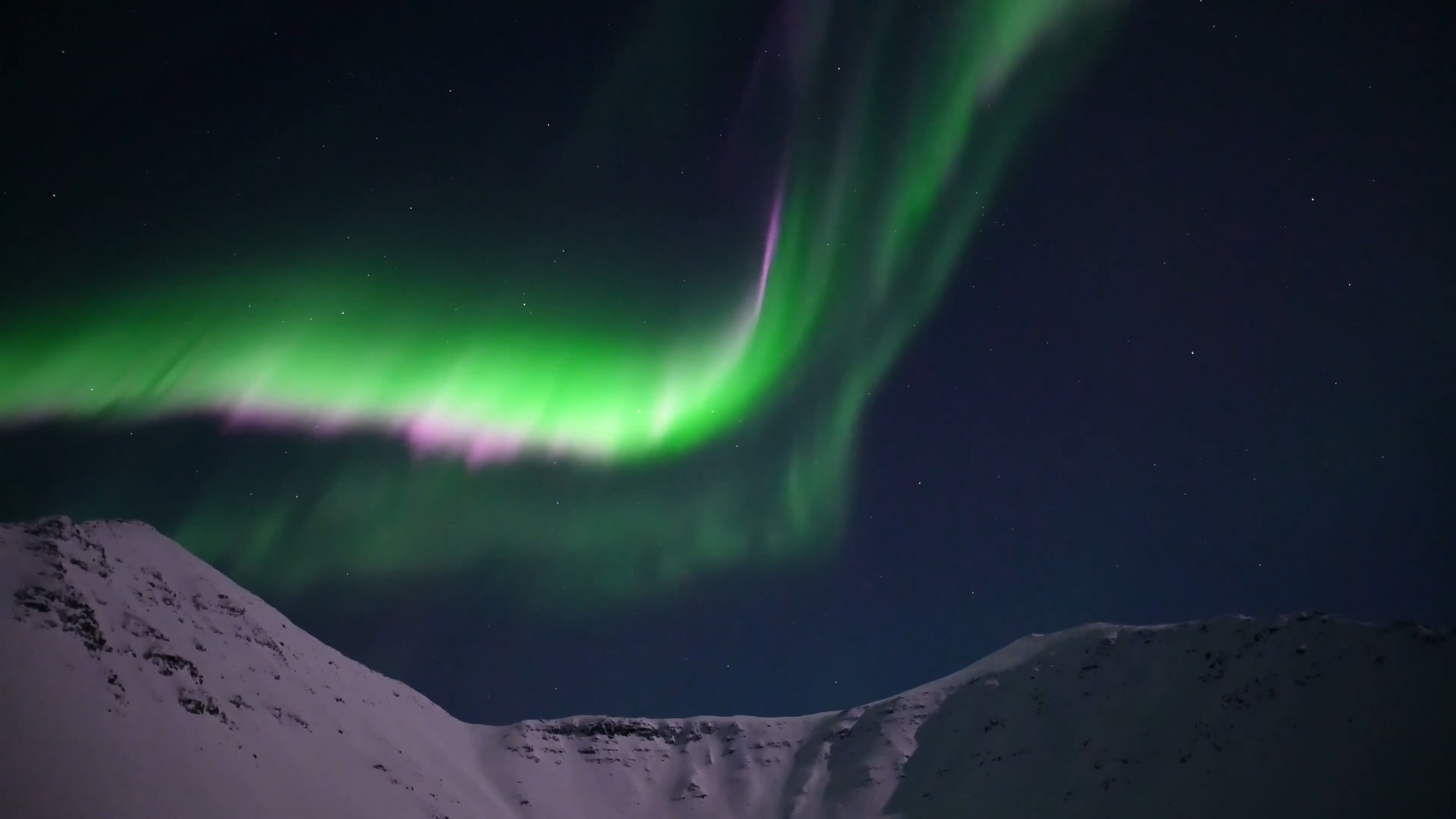 Real time video of aurora borealis over a moonlit Atigun Pass from the Dalton Highway in Alaska.